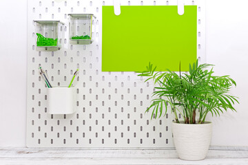 office desk with green stationery and a potted plant, order on the desk,