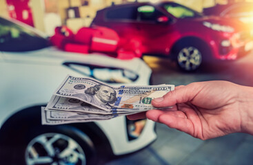 man doing purchase or rent car giving dollar salesman