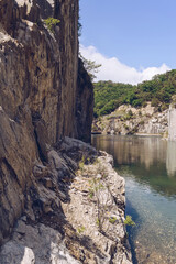 small lake inside rocky mountains on sunny day