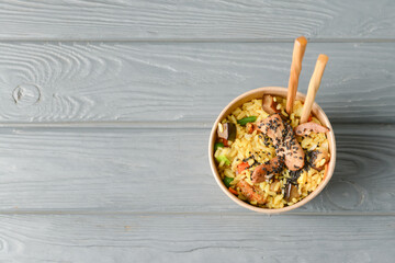 Box with tasty fried rice on table