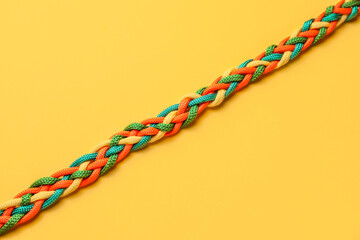 Braided ropes on color background