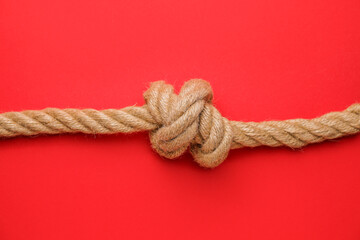 Rope with knot on color background