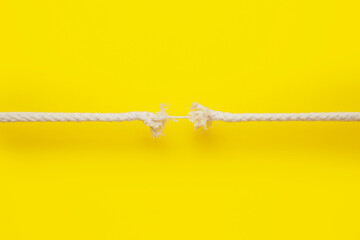 Frayed rope on color background