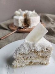 piece of vegetarian coconut cake on a white plate