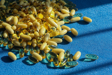 Transparent tablet capsule on blue background with shadows.