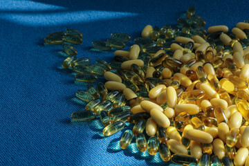 Transparent tablet capsule on blue background with shadows.