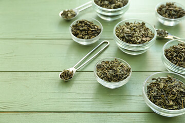Bowls with dry tea leaves on table