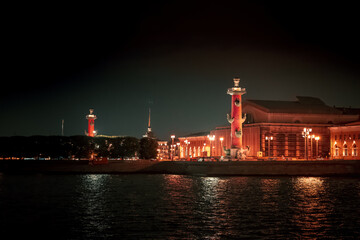 Fototapeta na wymiar View of the Neva river and Rostral columns at night in Saint Petersburg