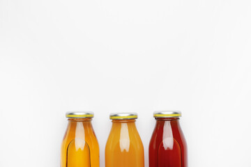 Bottles of juices on white background