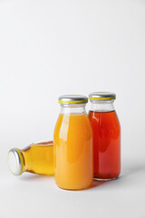 Bottles of juices on white background