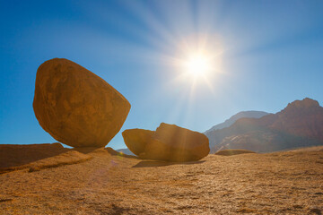 Landscape with granite boulders formed by spheroidal weathering in central Namibia in back-light