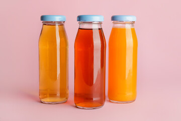 Bottles of juices on color background