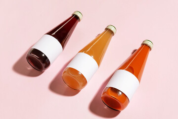 Bottles of juices on color background