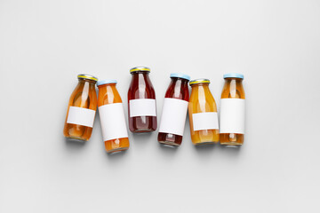 Bottles of juices on light background