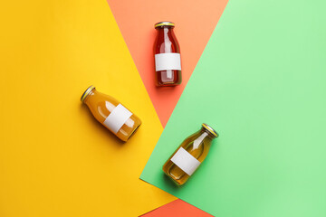 Bottles of juices on color background