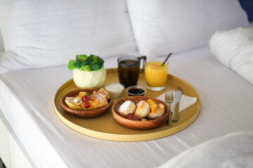 Breakfast in the hotel. Breakfast in bed with a flower. Coffee, juice and cheesecakes in bed. Eat in bed. Lazy weekend.