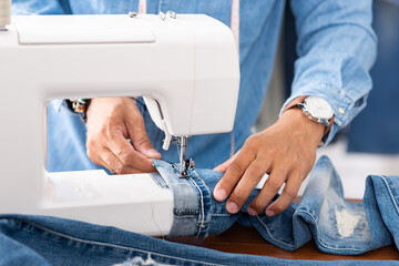 Obraz na płótnie Canvas tailor working with jeans.