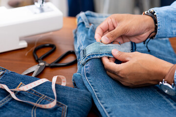 tailor working with jeans.