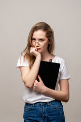New career. Stress anxiety. Portrait of worried female employee in glasses standing with clipboard...