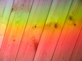 Rainbow colors sun light dispersion on wood planks