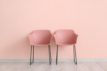 Modern chairs near color wall