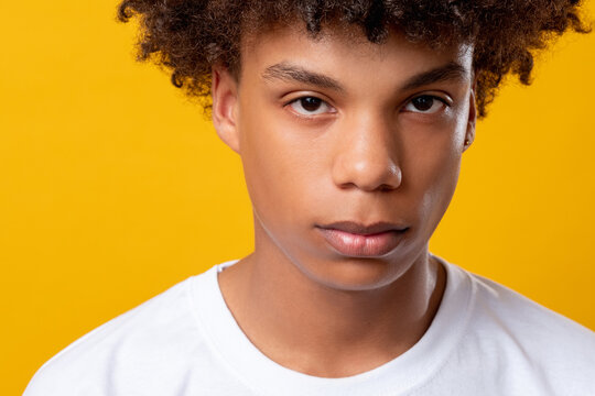Black lives matter. Teenager feelings. Young african guy looking at camera isolated on orange closeup. Social tolerance. Melancholic emotion. Advertising background
