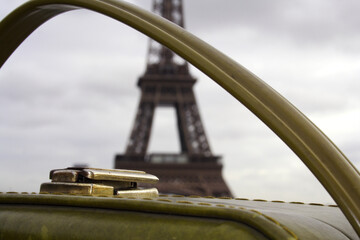 Fototapeta na wymiar Suitcase in the foreground and background the Eiffel Tower in Paris, concept travel to France.