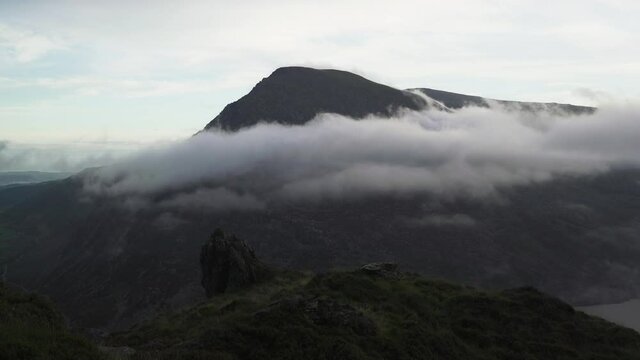 Beautiful low cloud below the mountain summit of Pen yr Ole Wen in Snowdonia Wales