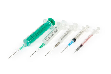 Different disposable medical syringes with needles on a white background
