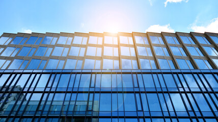 Office building, details of blue glass wall and sun reflections.