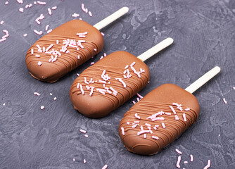 chocolate ice cream on a stick on a dark background