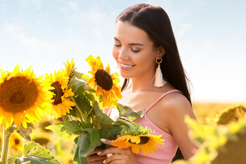 Beautiful young woman in sunflower field