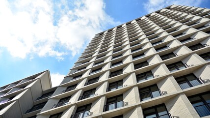 Exterior of a modern multi-story apartment building - facade, windows and balconies.