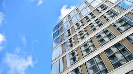 Office building, blue glass wall reflection detail. Modern office building and clear sky background. 