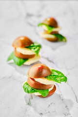 Brown chocolate tomato, mozzarella and basil cutted on slices and stacked