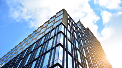 Office building, details of blue glass wall and sun reflections.