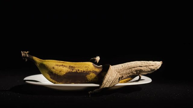 Composition Two bananas in plates - fresh and rotten