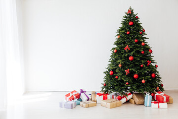 The interior of the white room is a green Christmas tree with red gifts for the new year decor winter holiday