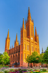 Fototapeta premium Evangelical Market Protestant church Wiesbaden or Marktkirche neo-Gothic style building on Schlossplatz Palace Square in historical city centre, blue sky background, State of Hesse, Germany