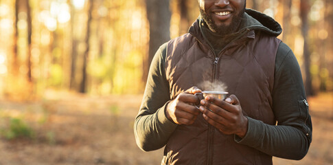 Cropped of man staying in forest with cup of tea