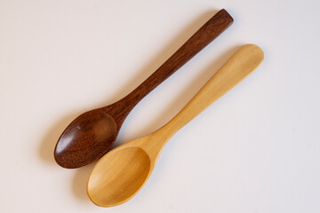 Two wooden spoons top view  on white background.