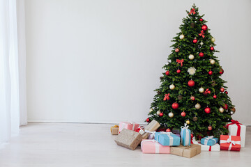 The interior of the room is a green Christmas tree with red gifts for the new year decor winter holiday