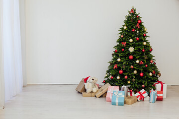 The interior of the room is a green Christmas tree with red gifts for the new year decor winter holiday