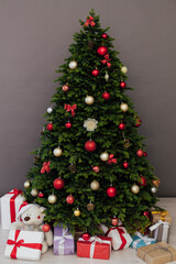 The interior of the room is a green Christmas tree with red gifts for the new year decor of the winter holiday home