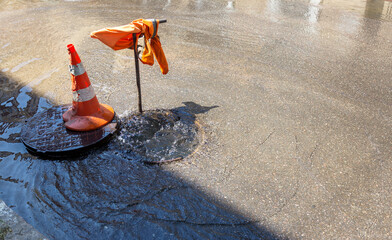Accident of water supply, sewage. Water fountain pours out from under the road sewer. Breakthrough...
