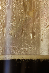 Small golden drops on the sweaty glass: coffee preparation in a cozy autumn morning.
