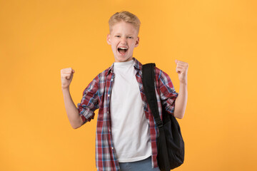 Little guy celebrating over orange studio background