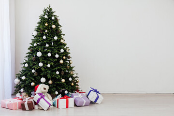 Christmas interior of the white room green Christmas tree with red gifts for the new year decor winter holiday