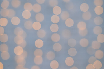 Christmas abstract blur background. Out of focus holiday background with christmas light. Holiday glowing glitter defocused background.Bokeh lens effect from lighting spots. Xmas and New Year theme.