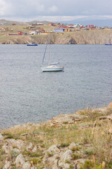 Fototapeta na wymiar Yacht in the bay against the background of the village